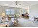 Open-concept living room with neutral tones, carpet, and views into the dining area at 11917 Bayonet Ln # 11917, New Port Richey, FL 34654