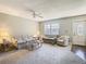 Cozy living room with a ceiling fan, large window, and comfortable furniture arrangement at 11917 Bayonet Ln # 11917, New Port Richey, FL 34654