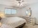 Serene main bedroom with a large window, ceiling fan, dresser and lamps for relaxing ambiance at 11917 Bayonet Ln # 11917, New Port Richey, FL 34654