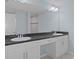 Bathroom featuring double sinks, granite countertops, a large mirror and a walk-in shower at 12493 Downy Woodpecker Rd, Brooksville, FL 34614