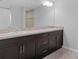 Bathroom vanity featuring double sinks, granite countertops, and modern fixtures at 13066 Nusser Ave, Weeki Wachee, FL 34614