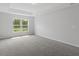 Spacious carpeted bedroom with a tray ceiling and a large window at 13066 Nusser Ave, Weeki Wachee, FL 34614
