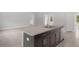 Kitchen island with granite countertop, stainless steel sink and appliances, tile flooring, and lots of light at 13066 Nusser Ave, Weeki Wachee, FL 34614