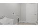 Functional laundry room with a utility sink and a white door, ready for your appliances at 13066 Nusser Ave, Weeki Wachee, FL 34614