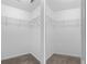 Dual walk-in closets, each featuring wire shelving and neutral color schemes at 13066 Nusser Ave, Weeki Wachee, FL 34614