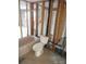 Incomplete bathroom with the tub fixture and white toilet, ready for remodel at 13610 Claudia Dr, Hudson, FL 34667