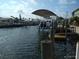 Canal view showcasing a boat lift, calm waters, and waterfront homes, ideal for boaters at 13610 Claudia Dr, Hudson, FL 34667