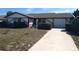 Charming single-story home featuring a well-maintained front yard and a single car garage at 13610 Claudia Dr, Hudson, FL 34667