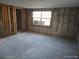 Spacious room with window and visible wall studs ready for customization at 13610 Claudia Dr, Hudson, FL 34667