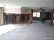 Open-concept space featuring framing and tile transition ready for renovation at 13610 Claudia Dr, Hudson, FL 34667
