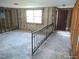 Spacious living room area ready for customization with a window and visible wall studs at 13610 Claudia Dr, Hudson, FL 34667