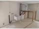 Utility room with water heater, utility sink and a small work bench at 13610 Claudia Dr, Hudson, FL 34667