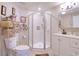 Well-maintained bathroom with tiled shower, white vanity, and decorative touches for a clean and inviting space at 13637 Allyn Dr, Hudson, FL 34667