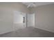 Bright bedroom featuring neutral carpet, ceiling fan, and seamless flow to other rooms at 13643 Pimberton Dr, Hudson, FL 34669