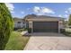 Inviting single-story home featuring a spacious garage and beautifully landscaped front yard at 13643 Pimberton Dr, Hudson, FL 34669