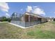 The backyard offers a screened-in patio, which provides a comfortable transition between indoor and outdoor living at 13643 Pimberton Dr, Hudson, FL 34669
