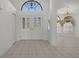 Elegant foyer with decorative glass front doors and transom window at 13643 Pimberton Dr, Hudson, FL 34669