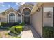 Attractive front entrance with unique architectural details and lush landscaping at 13643 Pimberton Dr, Hudson, FL 34669