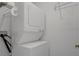 A practical laundry area with a stacked washer and dryer unit to maximize space at 13643 Pimberton Dr, Hudson, FL 34669