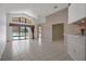 Bright and airy living room with tile floors and access to the outdoor pool area at 13643 Pimberton Dr, Hudson, FL 34669