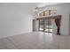 Spacious living area featuring tile flooring, high ceilings, and a view of the screened-in pool at 13643 Pimberton Dr, Hudson, FL 34669