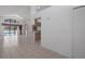 Open-concept living space with tile flooring, connecting the kitchen and outdoor pool area at 13643 Pimberton Dr, Hudson, FL 34669