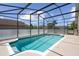 Inviting screened-in pool offers a refreshing escape with clear blue water and ample space for relaxation at 13643 Pimberton Dr, Hudson, FL 34669
