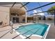 A clear, blue swimming pool with a screened lanai and sun deck at 13643 Pimberton Dr, Hudson, FL 34669