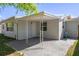 Exterior view of the home with a covered patio area and well-maintained lawn at 1721 Kenilworth St, Holiday, FL 34691