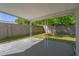 Outdoor covered patio area with concrete flooring and decorative support beams overlooking yard at 1721 Kenilworth St, Holiday, FL 34691