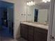 Bright bathroom featuring double sinks and a spacious vanity with elegant fixtures, providing modern comfort at 18336 Macek Rd, Weeki Wachee, FL 34614