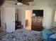 Relaxing bedroom with ceiling fan and wooden dresser, offering a serene retreat with ample natural light at 18336 Macek Rd, Weeki Wachee, FL 34614