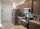 Kitchen featuring granite countertops, stainless appliances, and gray cabinets at 18336 Macek Rd, Weeki Wachee, FL 34614