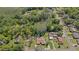 Beautiful aerial view of home with in-ground pool surrounded by lush green landscaping and mature trees at 19019 3Rd Ne St, Lutz, FL 33549