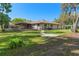 Expansive backyard featuring a screened-in patio, mature trees and ample green space at 19019 3Rd Ne St, Lutz, FL 33549