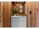 Cozy bar area with wood paneling, a sink, and ample storage space at 19019 3Rd Ne St, Lutz, FL 33549