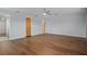 Spacious bedroom features wood-look floors, ceiling fan, and neutral paint at 19019 3Rd Ne St, Lutz, FL 33549