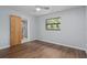 Bedroom featuring wood floors, light-colored walls, a ceiling fan, and an ensuite bathroom at 19019 3Rd Ne St, Lutz, FL 33549