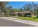 Charming single-story home featuring stone accents, mature trees and a well-manicured lawn at 19019 3Rd Ne St, Lutz, FL 33549