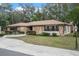Charming stone home with a circular driveway, mature trees, and manicured landscaping offers great curb appeal at 19019 3Rd Ne St, Lutz, FL 33549