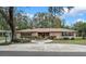 Charming stone home with a circular driveway, mature trees, and manicured landscaping offers great curb appeal at 19019 3Rd Ne St, Lutz, FL 33549
