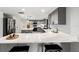 Modern kitchen with grey cabinets, quartz countertops, and stainless steel appliances at 19019 3Rd Ne St, Lutz, FL 33549