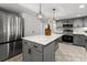 Well-equipped kitchen with stainless steel appliances, quartz countertops, and a large island at 19019 3Rd Ne St, Lutz, FL 33549
