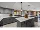 Stylish kitchen with grey cabinetry, quartz countertops, and a functional center island at 19019 3Rd Ne St, Lutz, FL 33549