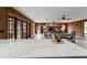 Spacious living room with wood paneling, stone fireplace and views from the kitchen island at 19019 3Rd Ne St, Lutz, FL 33549
