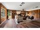 Spacious living room with wood paneled walls, built-in shelves, and a cozy stone fireplace at 19019 3Rd Ne St, Lutz, FL 33549