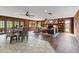 Expansive living and dining area with stone fireplace, wood paneling, and seamless transition at 19019 3Rd Ne St, Lutz, FL 33549