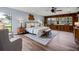 Large main bedroom featuring a window seat, sitting area, wood floors and ceiling fan at 19019 3Rd Ne St, Lutz, FL 33549