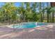 Inviting backyard pool and spa area with a brick paver patio, and black fence provide tranquil relaxation at 19019 3Rd Ne St, Lutz, FL 33549
