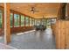 Spacious screened-in porch featuring wood paneling and ceiling fans at 19019 3Rd Ne St, Lutz, FL 33549